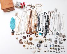 A collection of costume jewellery including silver pendant set with pressed amber, brooches