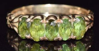 A 9ct gold ring set with five peridots, 2.2g, size L