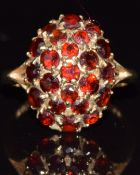 A 9ct gold ring set with garnets in a cluster, 2.9g, size K