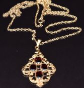 A 9ct gold pendant set with garnets and a 9ct gold chain, 62cm long, 8.3g