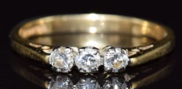 An 18ct gold ring set with three diamonds totalling approximately 0.25ct, 2.3g, size K
