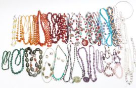 A collection of beaded necklaces including carved amethyst, Chinese carved amethyst with filigree