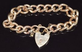 A 9ct gold curb link bracelet with heart padlock, 57.4g, 18cm long