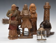 A collection of Bretton carved wood figures together with a novelty wall lamp formed as a lighthouse