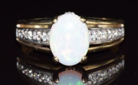 A 9ct gold ring set with an opal cabochon and white sapphires, 2.7g, size N