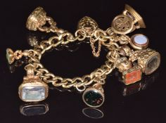 A 9ct gold bracelet with three seal fobs set with foiled quartz, agate and faux bloodstone, three