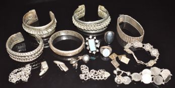 A collection of silver jewellery including bangle, three bracelets, rings and four pairs of