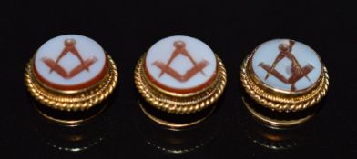 Three 15ct gold studs set with carved agate depicting Masonic symbols, 4.2g