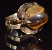 A 9ct gold ring set with a tiger's eye cabochon, London 1972, 9.9g, size J
