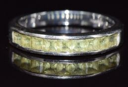 A 9ct white gold half eternity ring set with square peridot, 3g, size N