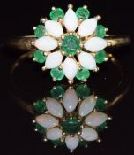 A 9ct gold ring set with opals and emeralds in a cluster, 1.8g, size N