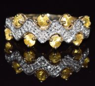 A 9ct gold ring set with yellow sapphires and diamonds, 2.6g, size M