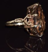A 9ct gold ring set with a pear cut smoky quartz, 8.7g, size L