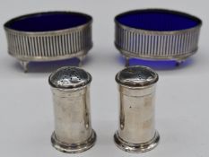 Pair of George V hallmarked silver salts with blue glass liners, Birmingham 1912, maker's mark H.