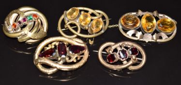 Victorian yellow metal knot brooch set with three garnets, and four gold plated Victorian knot