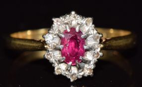 An 18ct gold ring set with a ruby surrounded by diamonds, 2.5g, size O