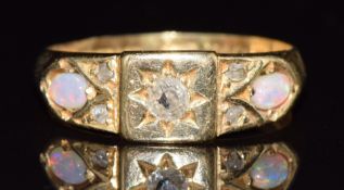 An 18ct gold ring set with an old cut diamond and two opals, Birmingham 1899, 2.6g, size H