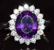 An 18ct white gold ring set with amethyst surrounded by diamonds, 4.8g, size K