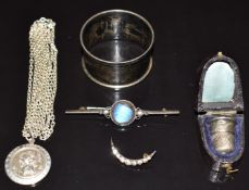 A silver St Christopher, Victorian silver brooch set with butterfly wing, silver crescent brooch set