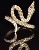 A 9ct gold ring in the form of a snake with ruby eyes, 2.6g