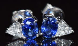 A pair of 18ct white gold earrings each set with an oval cut sapphire of approximately 0.7ct each