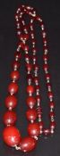 A single strand of cherry amber beads made up of 48 oval beads, 65g