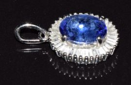 A platinum pendant set with an oval tanzanite of approximately 1.75ct surrounded by baguette cut