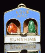 A c1920 yellow metal rotating charm/ pendant set with enamel reading 'love and sunshine', 1.1g