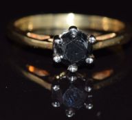 An 18ct gold ring set with a round cut black diamond, 3.7g, size O
