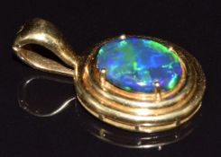 An 18ct gold pendant set with a black opal cabochon of approximately 3.6ct, 9.5g