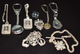 Five silver keyrings, a silver charm bracelet and two silver fobs