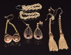 A pair of 9ct gold earrings set with garnets (3.5g), and three pairs of 9ct gold/ yellow metal