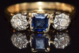 An 18ct gold ring set with a square cut sapphire and diamonds, 2.8g, size L