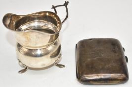 Hallmarked silver cigarette case together with a hallmarked silver milk jug raised on three feet,