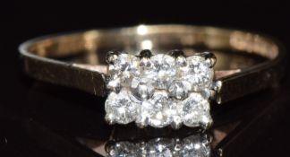 A 9ct gold ring set with six diamonds in a rectangular setting, 1.6g, size P