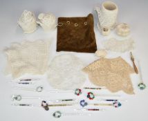 Small collection of handmade glass and bone lace bobbins, pieces of lace, velvet bag etc
