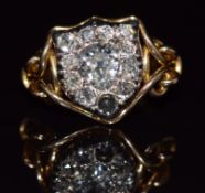 A c1900 18ct gold ring set with a old pear cut diamond of approximately 0.85ct surrounded by further