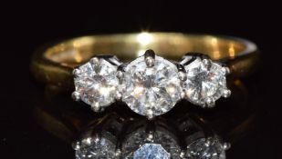 An 18ct gold ring set with three round brilliant cut diamonds, the largest approximately 0.3ct,