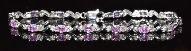 A 14k white gold bracelet set with pink sapphires and diamonds, 5.6g, 18cm long