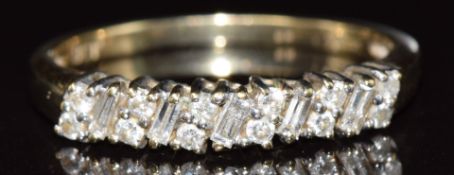 An 18ct gold ring set with baguette cut and round cut diamonds, 1.9g, size P