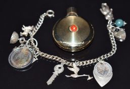 A silver charm bracelet with nine silver charms including spaniel, heart shaped pendant set with