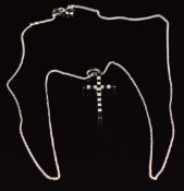 An 18ct white gold cross set with diamonds totalling approximately 0.21ct, on 18ct gold chain,