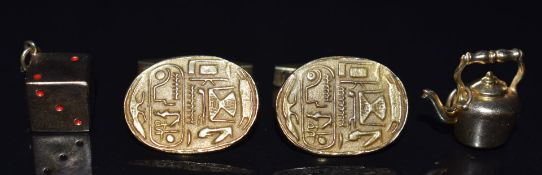 A pair of 9ct gold cufflinks with embossed Egyptian decoration, a 9ct gold dice charm and a 9ct gold