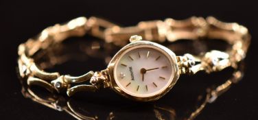 Accurist 9ct gold ladies wristwatch with gold hands and hour markers, mother of pearl dial and