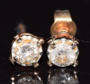 A pair of 9ct gold earrings, each set with a diamond of approximately 0.15ct, 0.7g