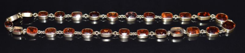 Victorian yellow metal necklace set with garnets, a replacement paste and a zircon, 23.8g, 40cm