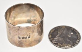 Maria Theresa silver coin and a hallmarked silver napkin ring, weight 95g all in