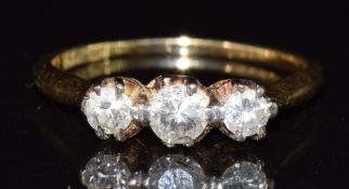 An 18ct gold ring set with three diamonds, the largest approximately 0.2ct, 2.4g, size M