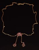 Victorian 9ct necklace set with three sections of foiled garnets, the central section set with a