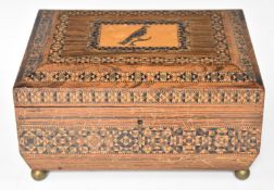 Tunbridgeware work box and contents including Tunbridge cotton reels, raised on four brass ball